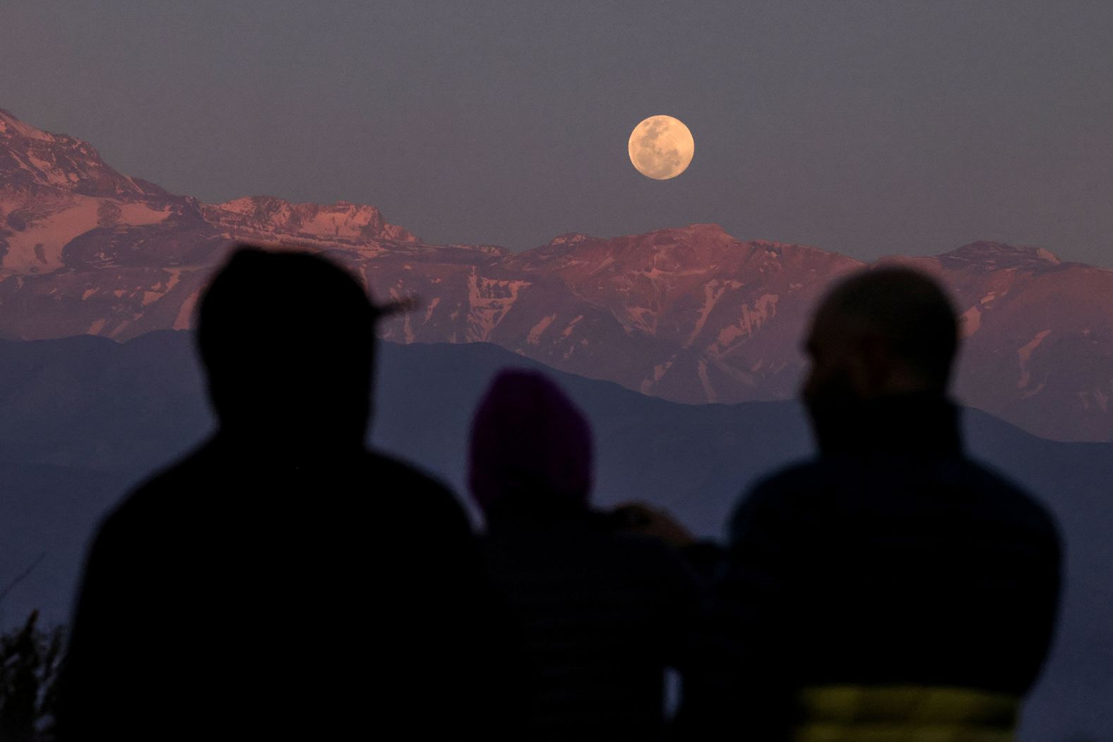 The moon is seen over the Andes mountain range in Santiago, Chile, on Wednesday.