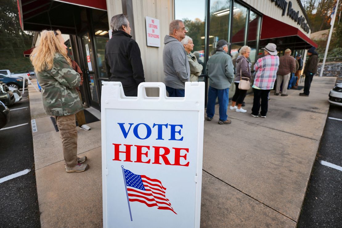 Voters wait in line to cast their ballots on the first day of early in-person voting in Marion, North Carolina, on October 17.