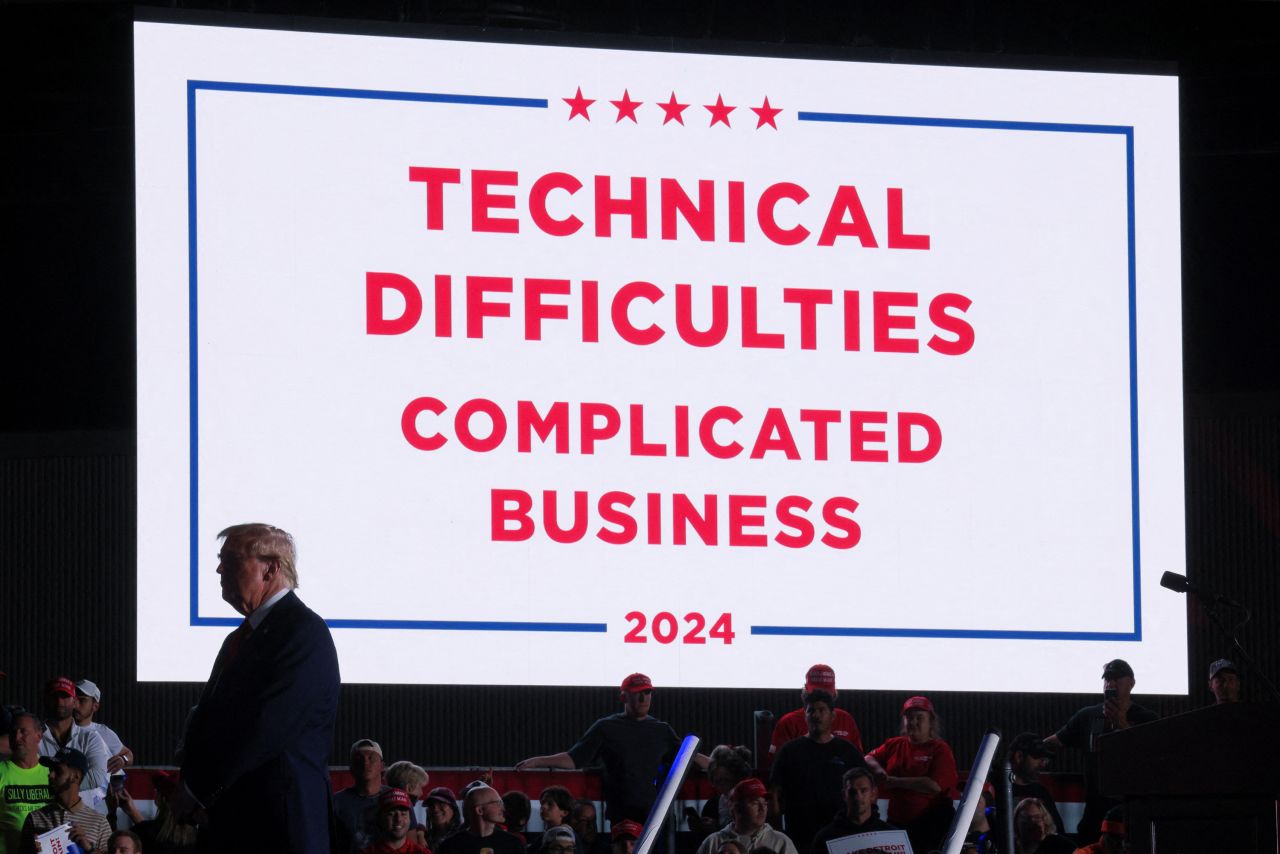 Donald Trump waits after the sound system stopped working during a rally in Detroit, Michigan, on October 18.