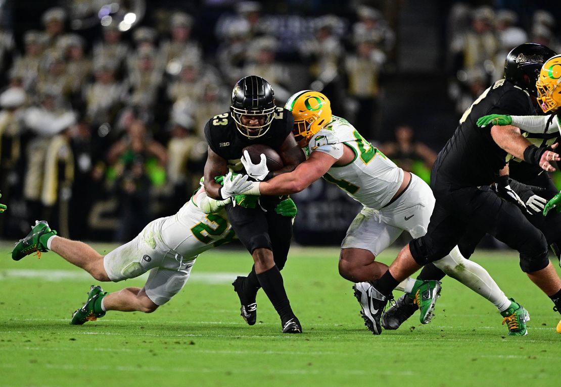 October 18, 2024; West Lafayette, Indiana, USA; Purdue Boilermakers running back Reggie Love III (23) is tackled by Oregon Ducks linebacker Teitum Tuioti (44) during the second half at Ross-Ade Stadium. Mandatory credits: Marc Lebryk-Imagn Images