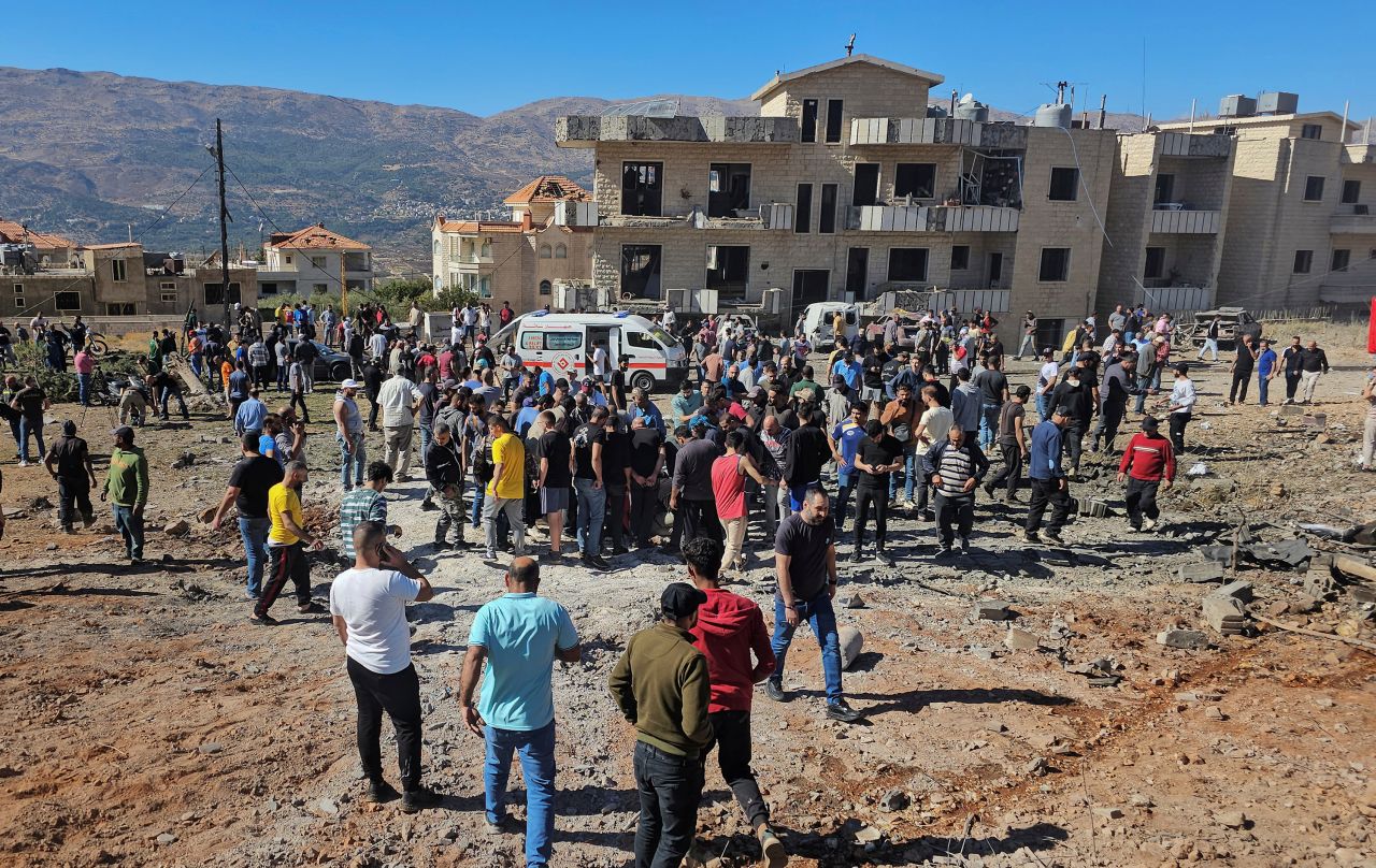 People and rescuers inspect the site of an Israeli strike in Baaloul, a town in the western Beqaa Valley in Lebanon, on October 19.