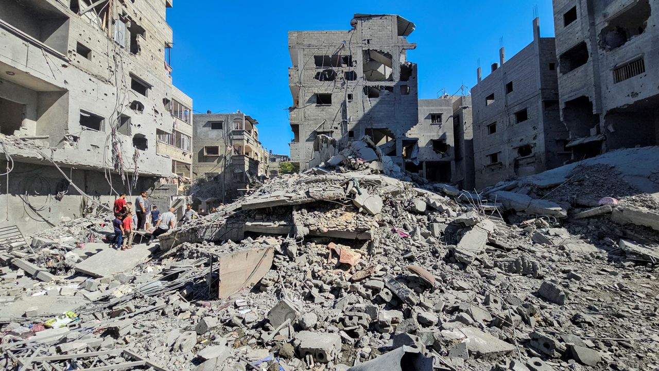 Palestinians gather at the site of Israeli strikes on houses and residential buildings in Beit Lahiya, in northern Gaza, on October 20.