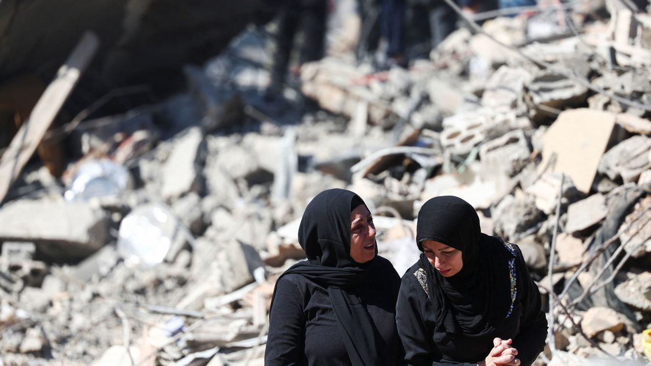 Women react at the site of an Israeli strike near Rafik Hariri University Hospital in Beirut, Lebanon, on October 22.