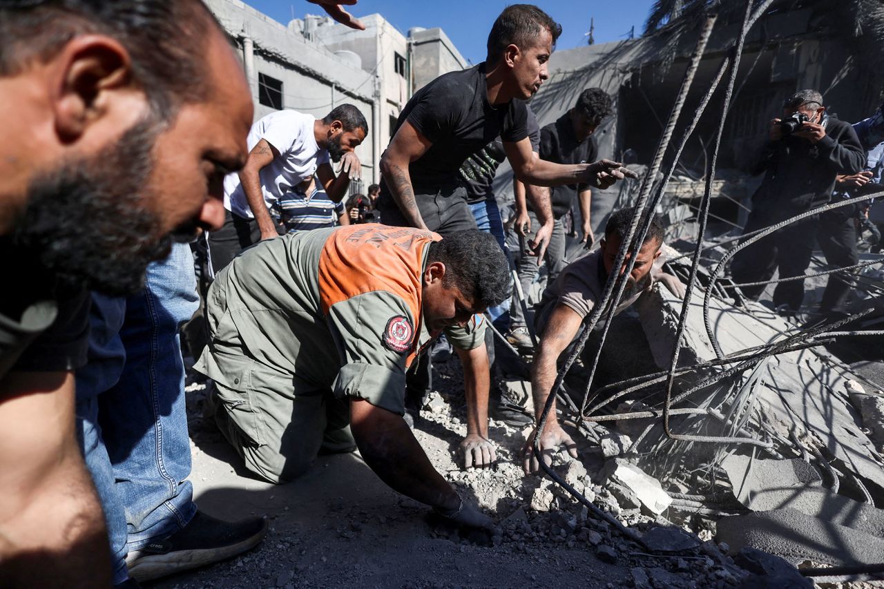 People search through the rubble at the site of an Israeli strike near Rafik Hariri University Hospital in Beirut, Lebanon, on October 22.