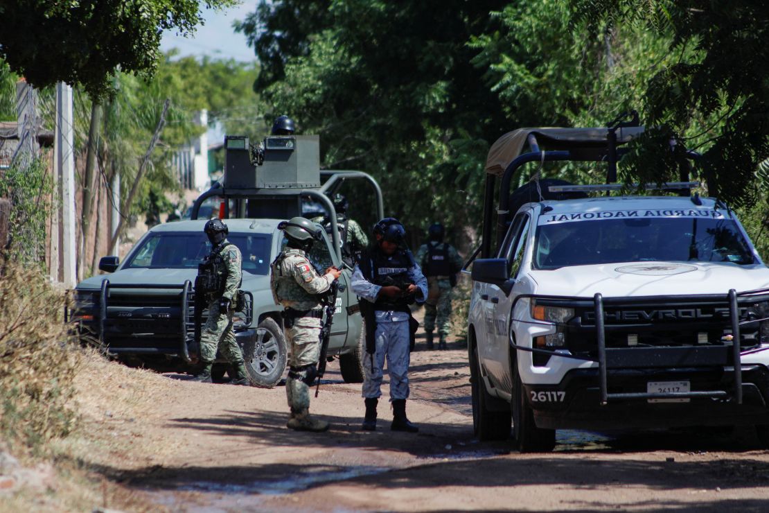 Mexican federal forces guard the perimeter of a scene following a shootout where several suspected gang members were killed while one local cartel leader was arrested on the outskirts of Culiacan, Sinaloa state, Mexico, on October 22, 2024.