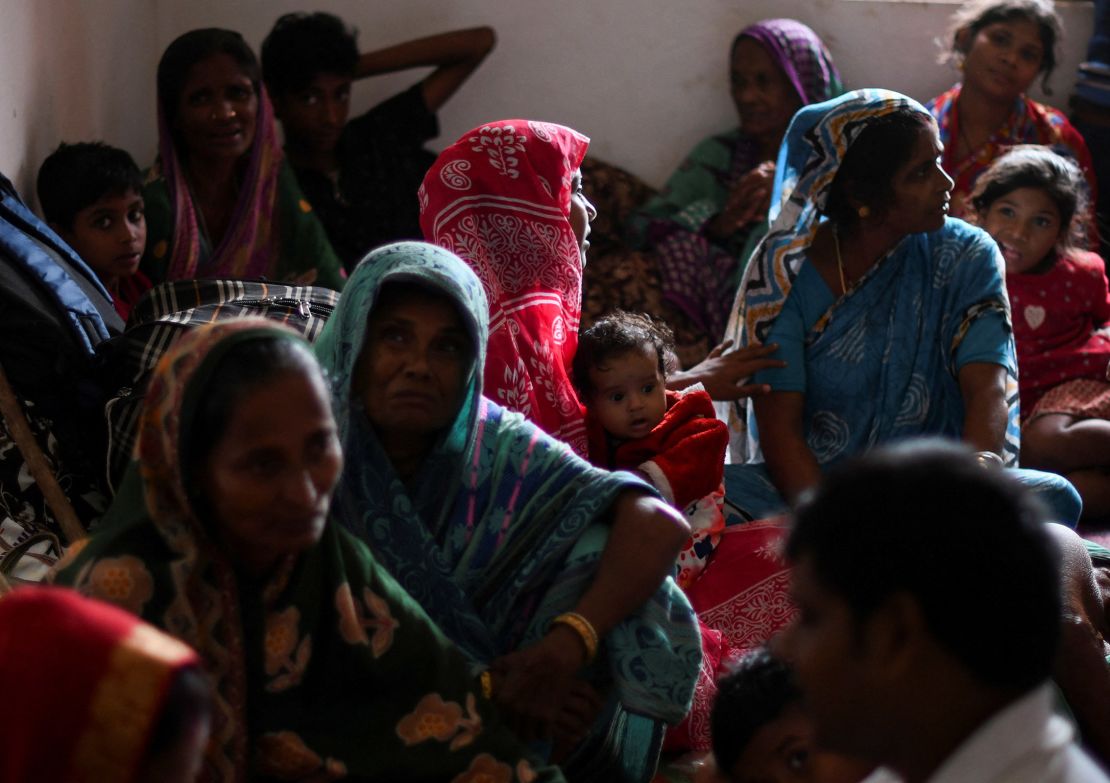 Evacuated villagers sit inside a cyclone shelter near Dhamara fishing harbor in Odisha's Bhadrak district, on October 24, 2024.