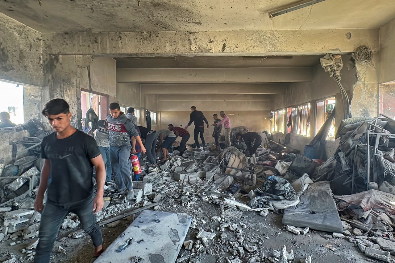 Palestinians inspect the site of an Israeli strike on a school sheltering displaced people in Nuseirat, Gaza, on October 24.