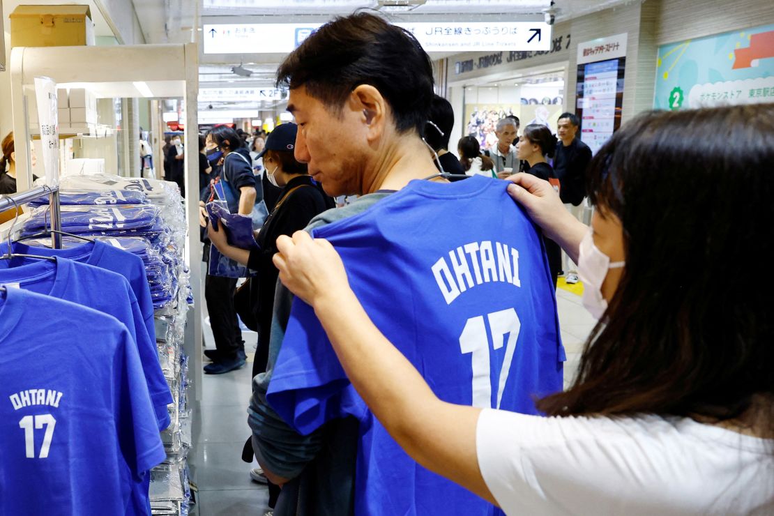 Customers select a T-shirt at a pop-up store for Major League Baseball star Shohei Ohtani prior to the first game of the World Series between the Los Angeles Dodgers and the New York Yankees in Tokyo, Japan, on October 25, 2024.