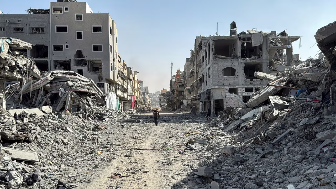 A Palestinian man walks past the rubble after Israeli forces withdrew from the area around Kamal Adwan hospital in northern Gaza on October 26.