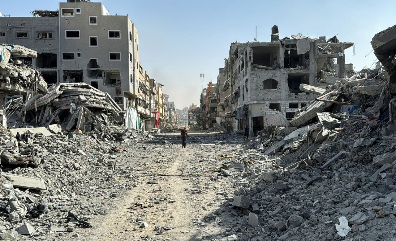 A Palestinian man walks past the rubble after Israeli forces withdrew from the area around Kamal Adwan hospital in northern Gaza on October 26.