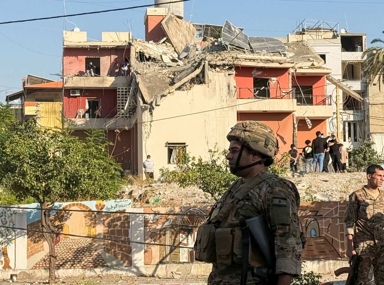 Lebanese army soldiers stand near the site of an Israeli strike in Sidon, Lebanon on October 27.