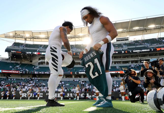 Cincinnati Bengals running back Chase Brown, left, and his identical twin brother, Philadelphia Eagles safety Sydney Brown, exchange jerseys after the game between their teams in Cincinnati on Sunday, October 27. The Eagles won 37-17.