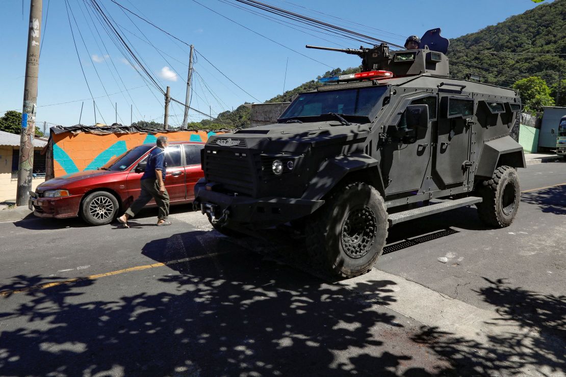 Soldiers patrol a neighborhood in San Marcos, El Salvador, in an armored vehicle on October 28, 2024, after Nayib Bukele announced the deployment of security forces to search gang remnants.
