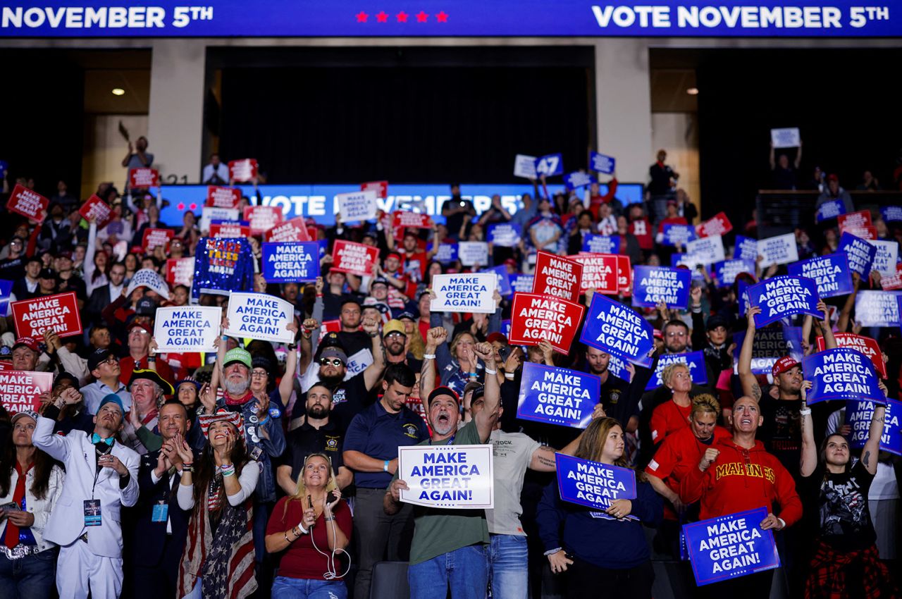 Supporters hold "Make America great again" placards as they attend a campaign event for Republican presidential nominee, former President Donald Trump in Allentown, Pennsylvania, on October 29, 2024.