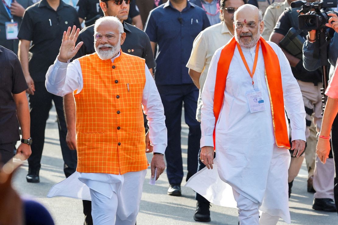 India's Prime Minister Narendra Modi (L) walks alongside Home Affairs Minister Amit Shah outside a polling station during India's general election, in Ahmedabad, India, on May 7, 2024.