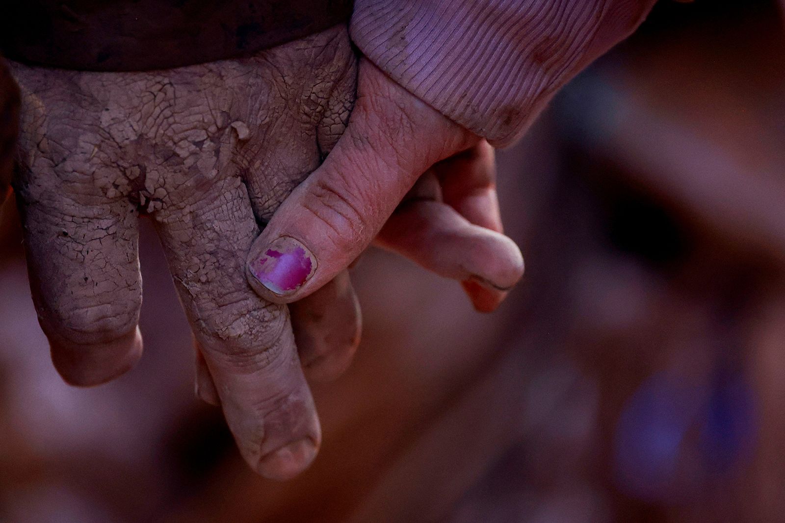 A couple holds hands outside their home in Utiel on Wednesday.