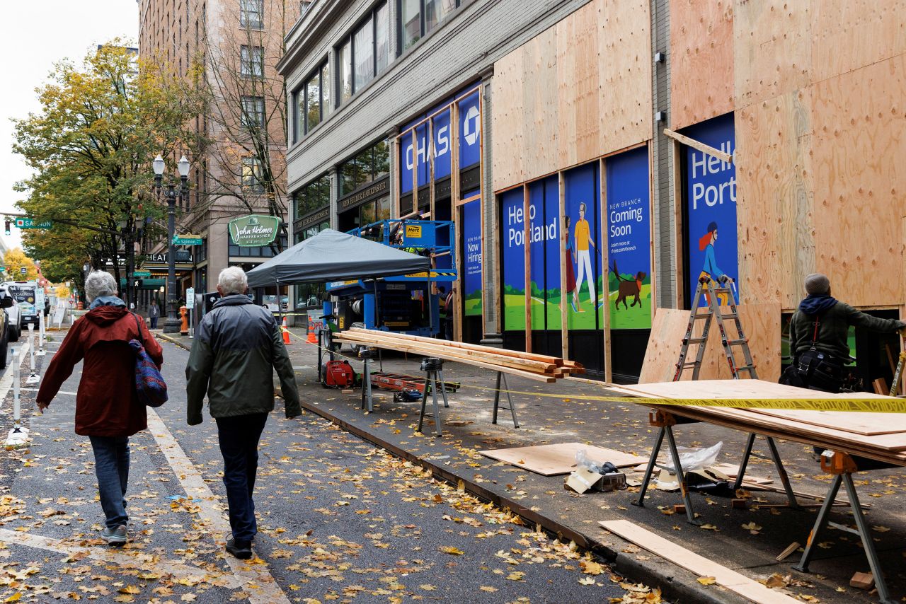 People walk past a blocked bank in preparation for potential election protests in Portland, Oregon, on November 1.