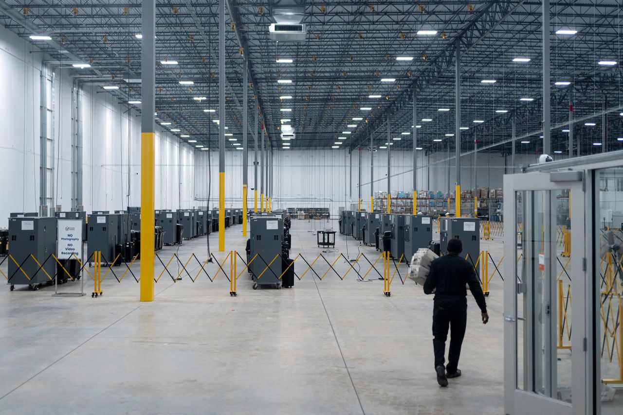 A man walks at the Fulton County Operations Hub and Elections Center in Atlanta, on Monday.