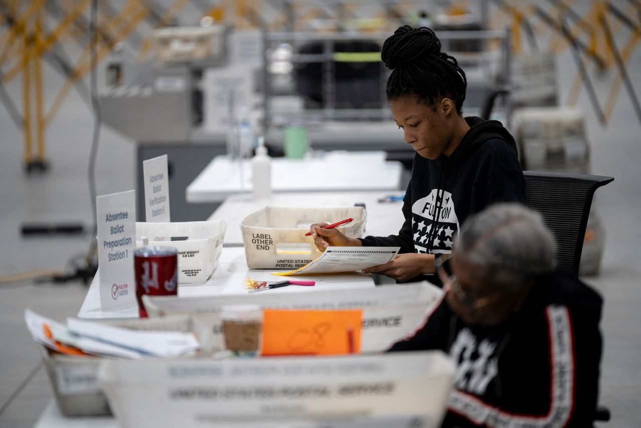 Workers process absentee ballots at Fulton County Operations Hub and Elections Center, in Atlanta on Monday.