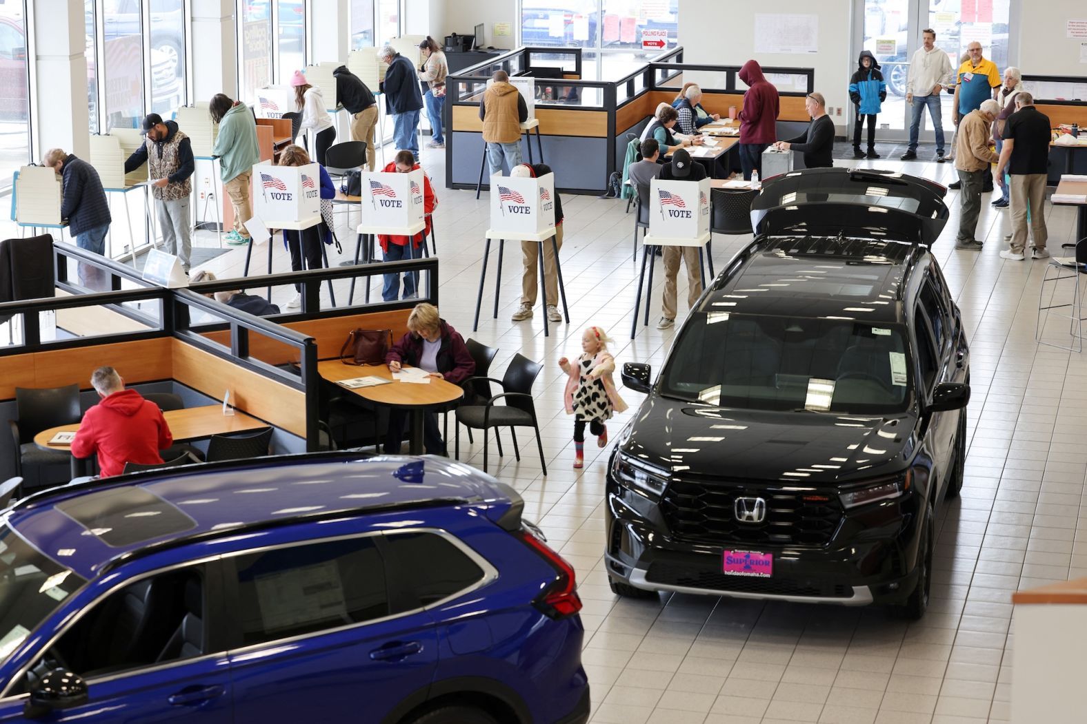 People vote in the showroom of a Honda dealership in Omaha, Nebraska, on Tuesday.