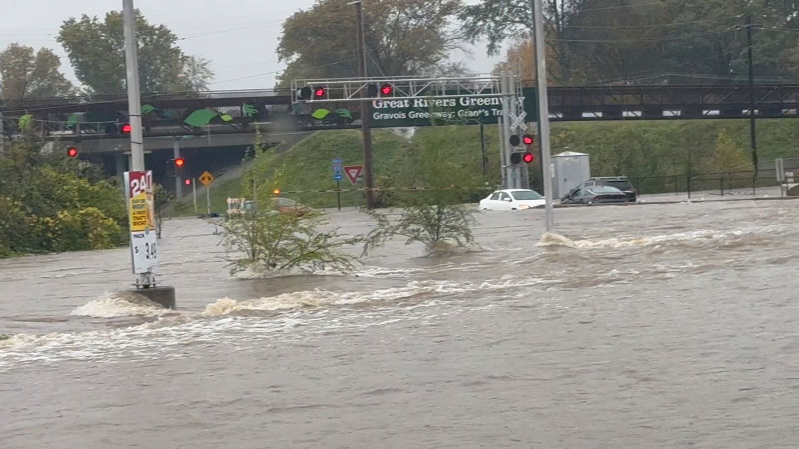 Vehicles are partially submerged by floodwaters caused by heavy rain in St. Louis on Tuesday in this still image obtained from social media video.