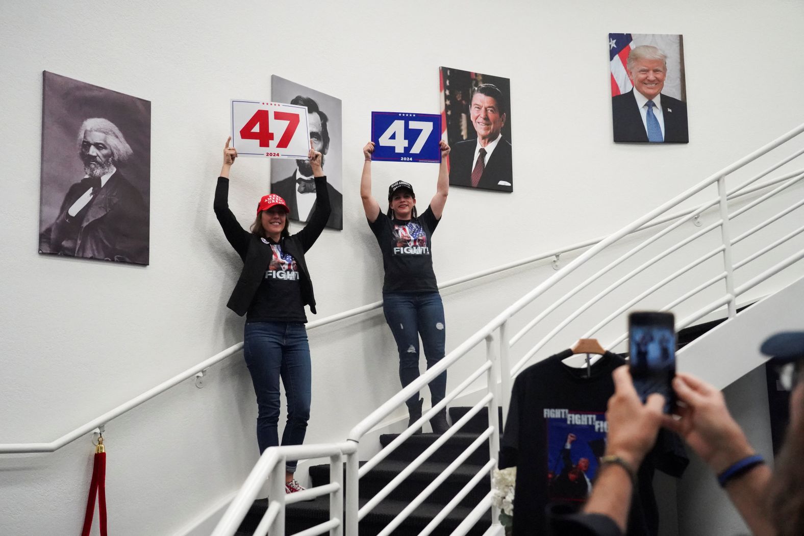 Trump supporters hold up posters that read "47" as they attend an election watch party in Chandler, Arizona.