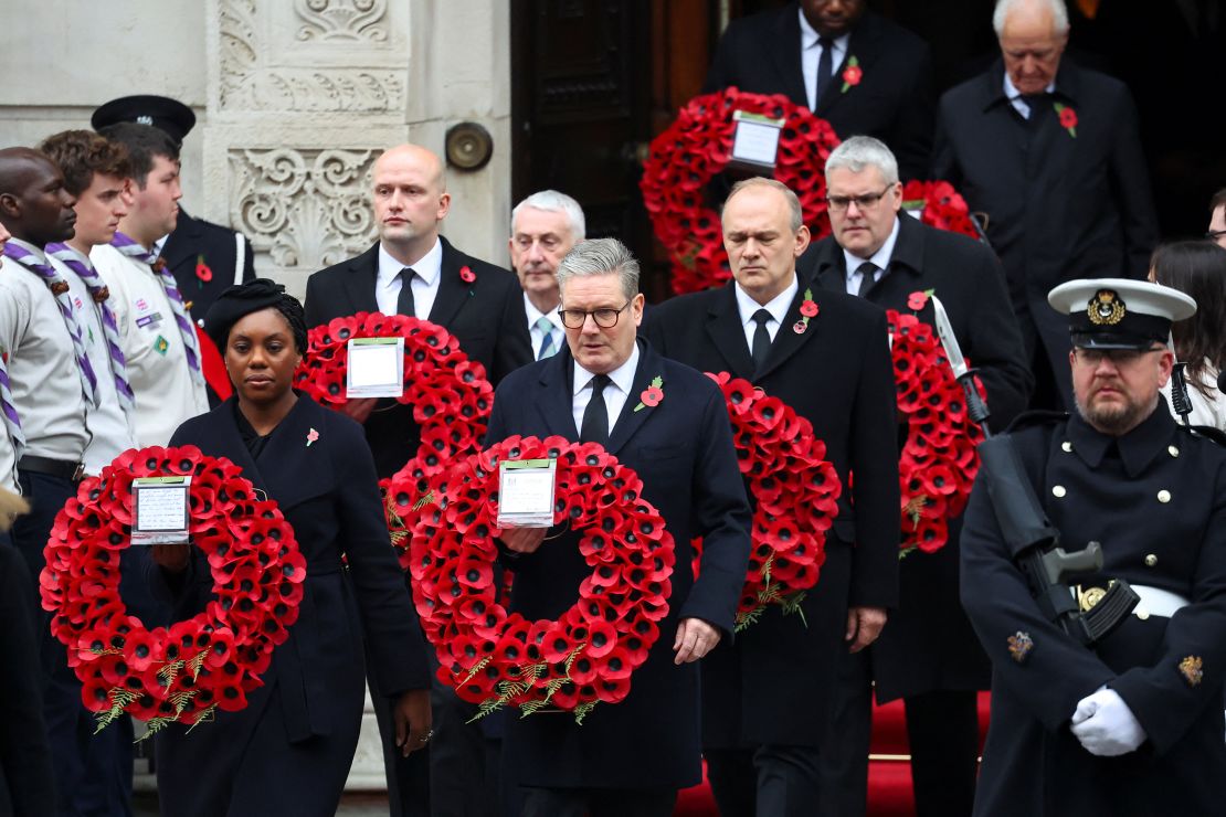 British Prime Minister Keir Starmer and Conservative Party leader Kemi Badenoch carry wreaths as they attend the Sunday ceremony.