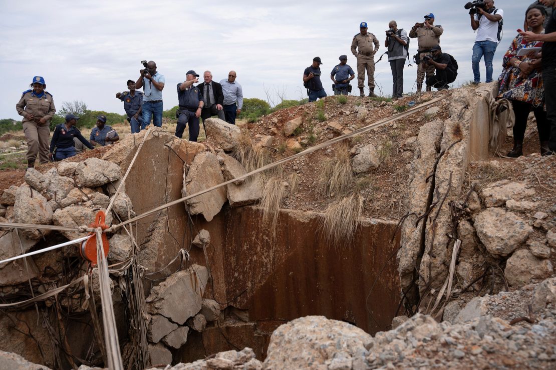 People watch as Senzo Mchunu, South African police minister (not pictured), inspects outside the mineshaft where it is estimated that hundreds of illegal miners are believed to be hiding underground, after police cut off food and water as part of police operations against illegal miners, in Stilfontein, South Africa, November 15, 2024.