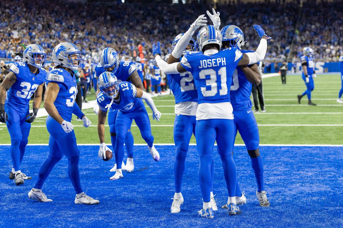 Nov 17, 2024; Detroit, Michigan, USA; Detroit Lions safety Kerby Joseph (31) intercepts a pass intended for Jacksonville Jaguars tight end Patrick Murtagh (88) and celebrates with teammates during the second half at Ford Field. Mandatory Credit: David Reginek-Imagn Images