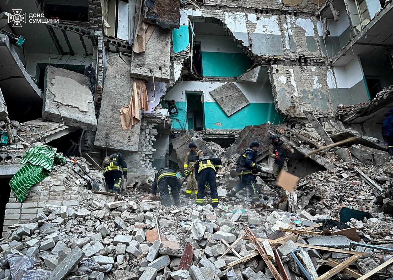 Rescuers work at a residential building hit by a Russian drone strike in the town of Hlukhiv, Sumy region, Ukraine, in this handout picture released on November 19.