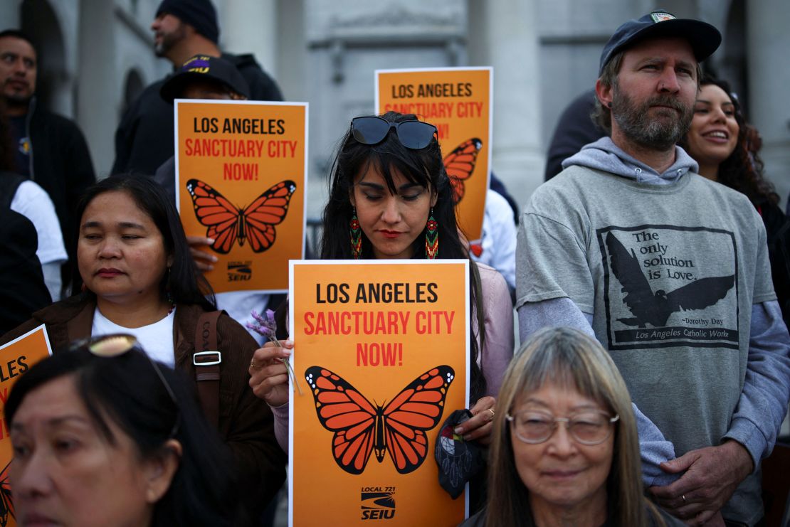 Protesters attend a pro-immigration rally as the Los Angeles City Council meets to consider adopting a 