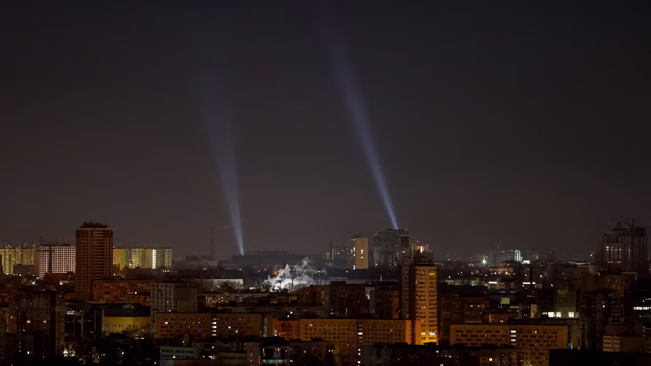 Ukrainian service personnel use searchlights as they search for drones in the sky over the city during a Russian drone strike in Kyiv, Ukraine, on November 20.