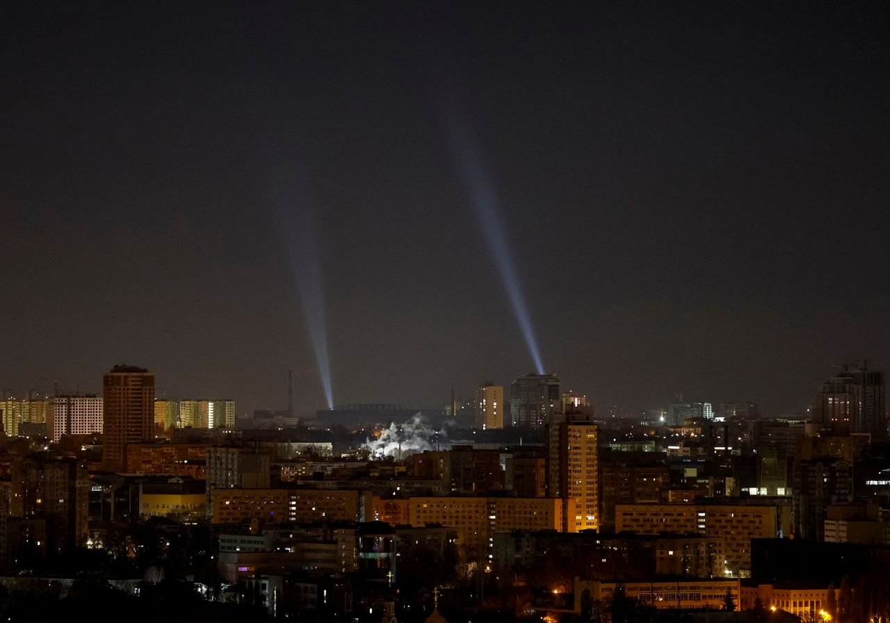 Ukrainian service personnel use searchlights as they search for drones in the sky over the city during a Russian drone strike in Kyiv, Ukraine, on November 20.