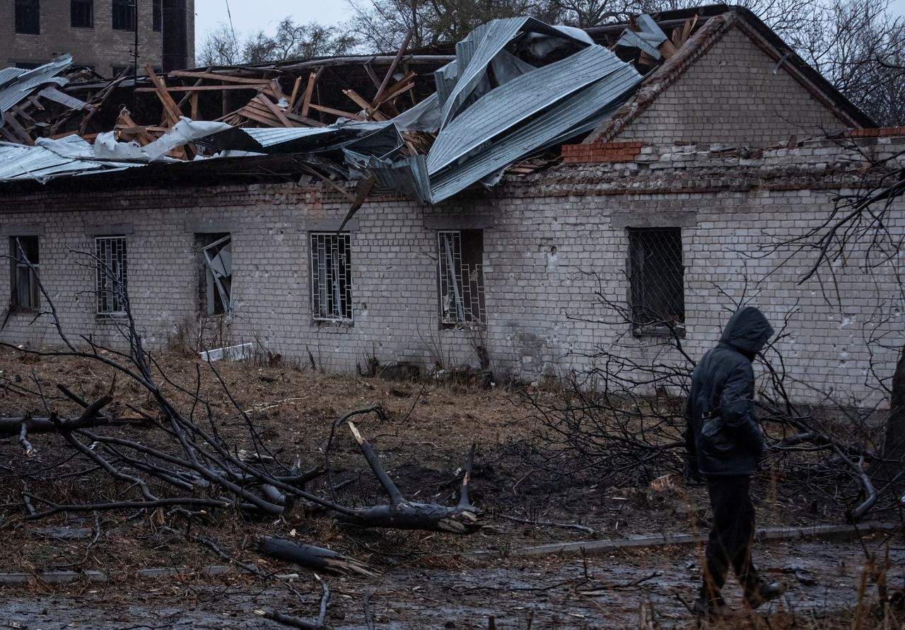 A resident walks at the site of a Russian missile strike in Dnipro, Ukraine, on November 21, 2024.