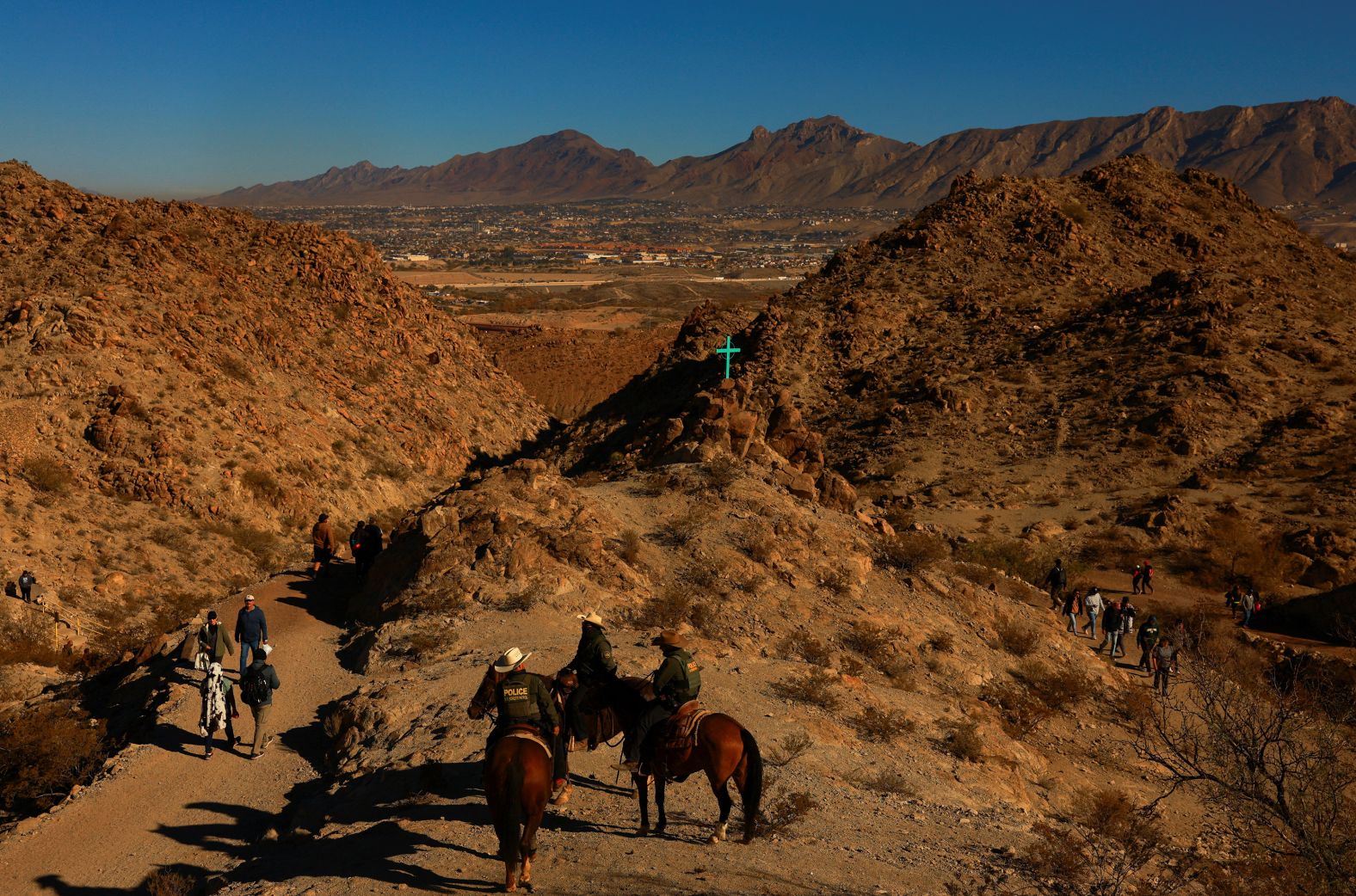 Mounted U.S. Border Patrol agents stand watch as faithful participate in a pilgrimage during the Solemnity of Christ the King to pray for peace, at Mount Cristo Rey, on the border between the United States and Mexico, in Sunland Park, New Mexico, U.S., November 23, 2024. REUTERS/Jose Luis Gonzalez