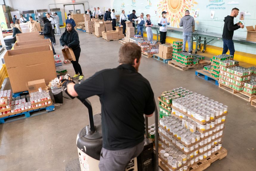 Volunteers assemble boxes of food for seniors ahead of the holidays at the Capital Area Food Bank in Washington, U.S., November 27, 2024.
