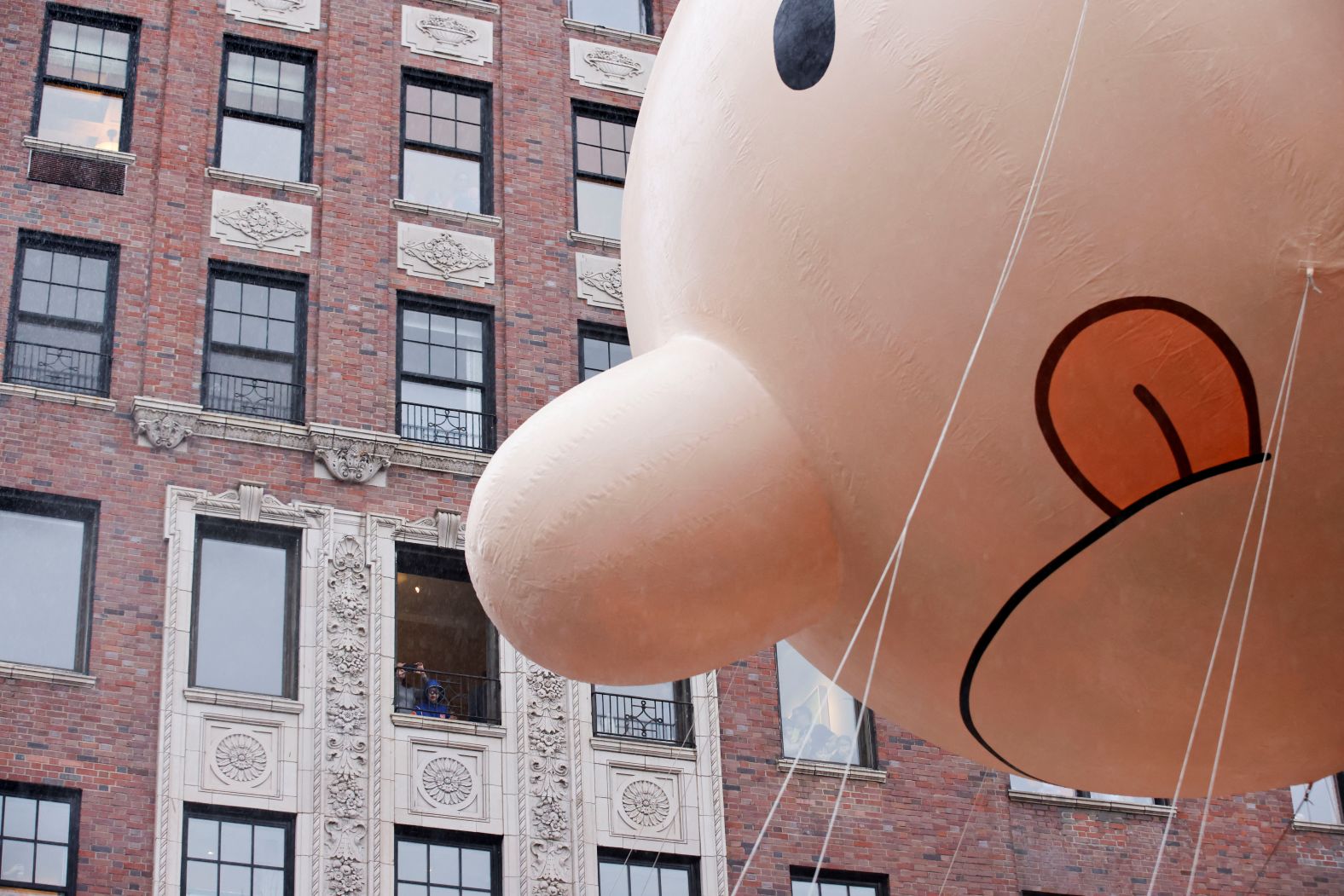 People in New York watch the "Diary of a Wimpy Kid" balloon go by.