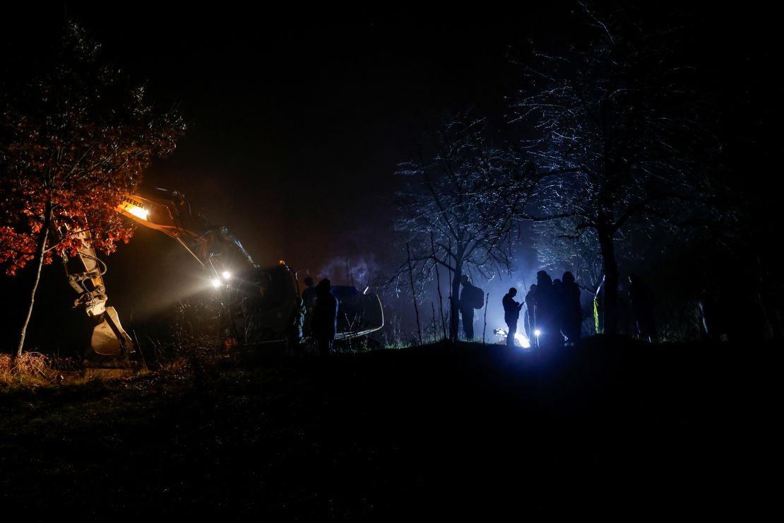 People stand near the damaged canal in northern Kosovo supplying water to two coal-fired power plants that generate nearly all of the country's electricity, in Varage, Kosovo November 30, 2024.