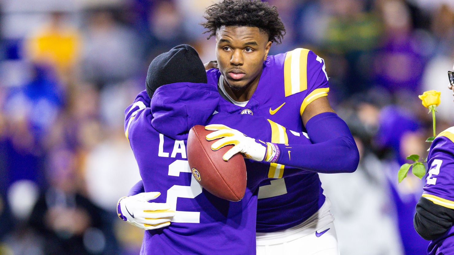 Nov 30, 2024; Baton Rouge, Louisiana, USA; LSU Tigers wide receiver Kyren Lacy (2) hugs his family as seniors are being honored during the beginning of the first quarter at Tiger Stadium. Mandatory Credit: Stephen Lew-Imagn Images