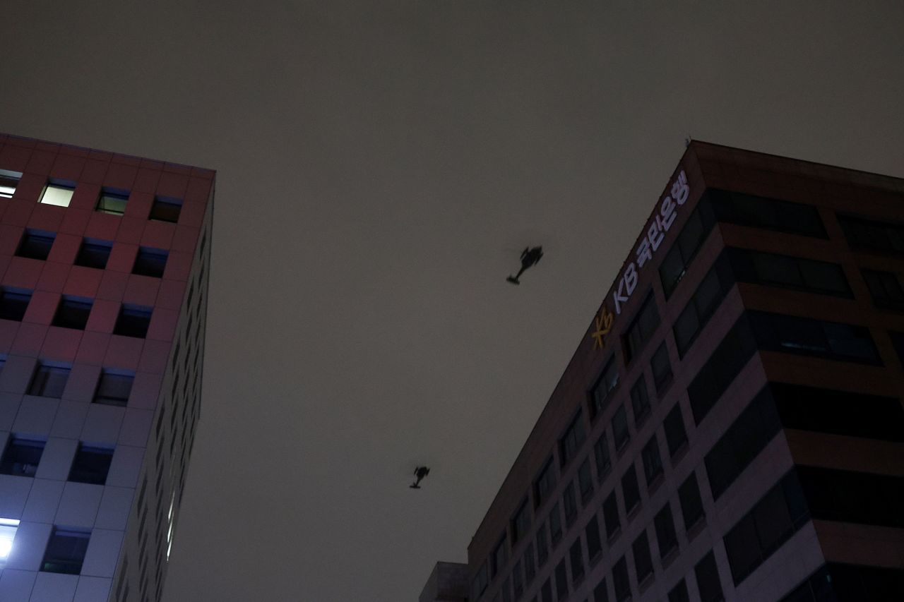 Helicopters fly after South Korean President Yoon Suk Yeol declared martial law.