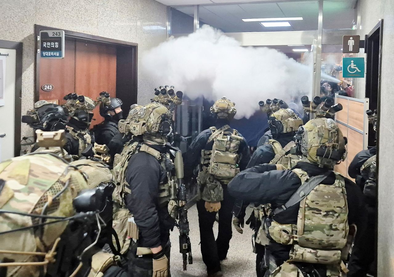 Soldiers advance to the main building of the National Assembly after South Korean President Yoon Suk Yeol declared martial law.