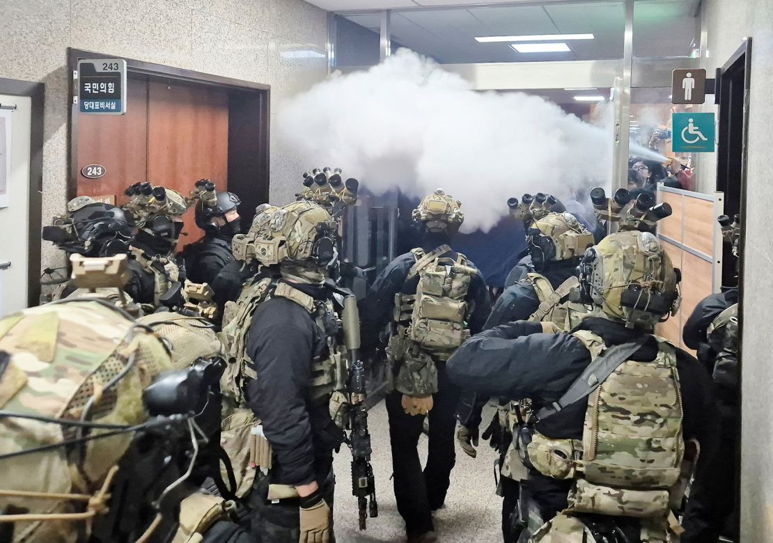 Soldiers advance to the main building of the National Assembly following the South Korean President's announcement.