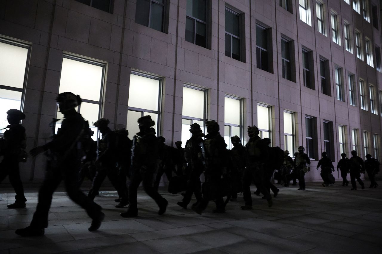 Military forces move outside the National Assembly in Seoul, South Korea, on December 4, after President Yoon Suk Yeol declared martial law.