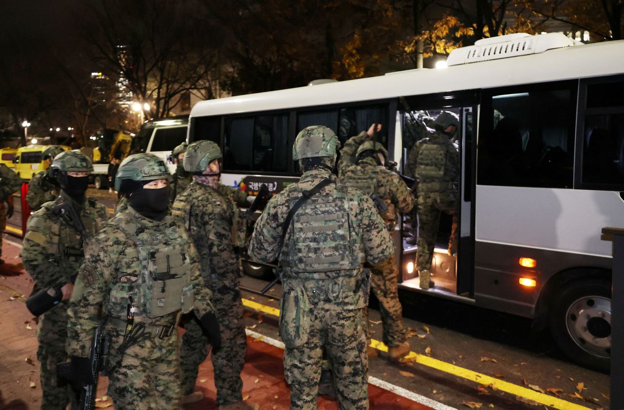 Soldiers leave the National Assembly in Seoul after South Korea's parliament passed a motion requiring the martial law declared by President Yoon Suk Yeol to be lifted in the early hours of December 4.