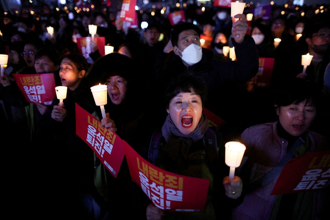 People attend a candlelight vigil condemning South Korean President Yoon Suk Yeol's surprise declaration of martial law last night, which was reversed hours later, and to call for his resignation, in Seoul, South Korea, on December 4, 2024.