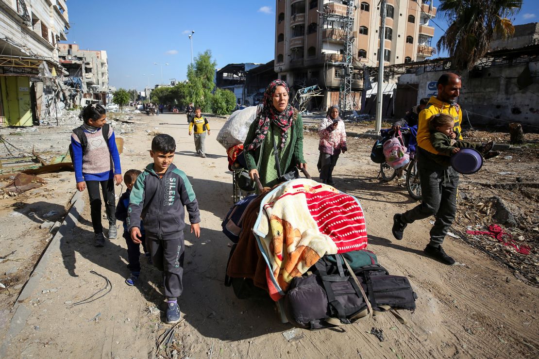 Palestinians flee Israeli attacks in Jabalya, in northern Gaza, on December 4. Human rights agencies say Israel's aid restrictions have depleted food and water stocks in the area.