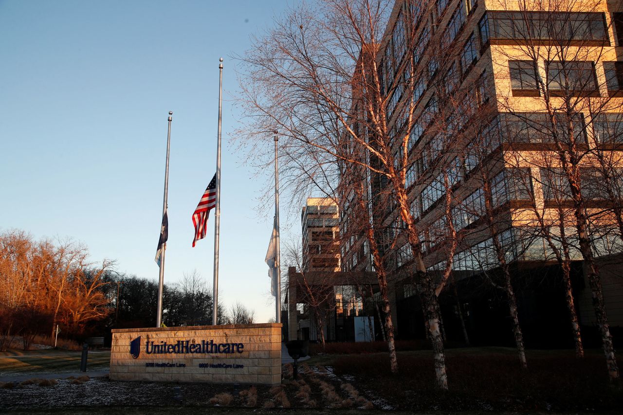 Flags fly at half-staff outside the UnitedHealthcare office in Minnetonka, Minnesota, on Dec. 5.