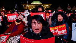 A protestor holds a placard during a rally calling for the impeachment of South Korean President Yoon Suk Yeol, who declared martial law, which was reversed hours later, in front of the National Assembly in Seoul, South Korea, on December 7, 2024.