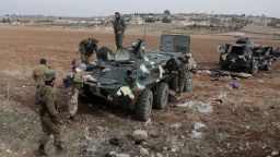 A rebel fighter stands on a military vehicle in Homs, Syria, on December 7.