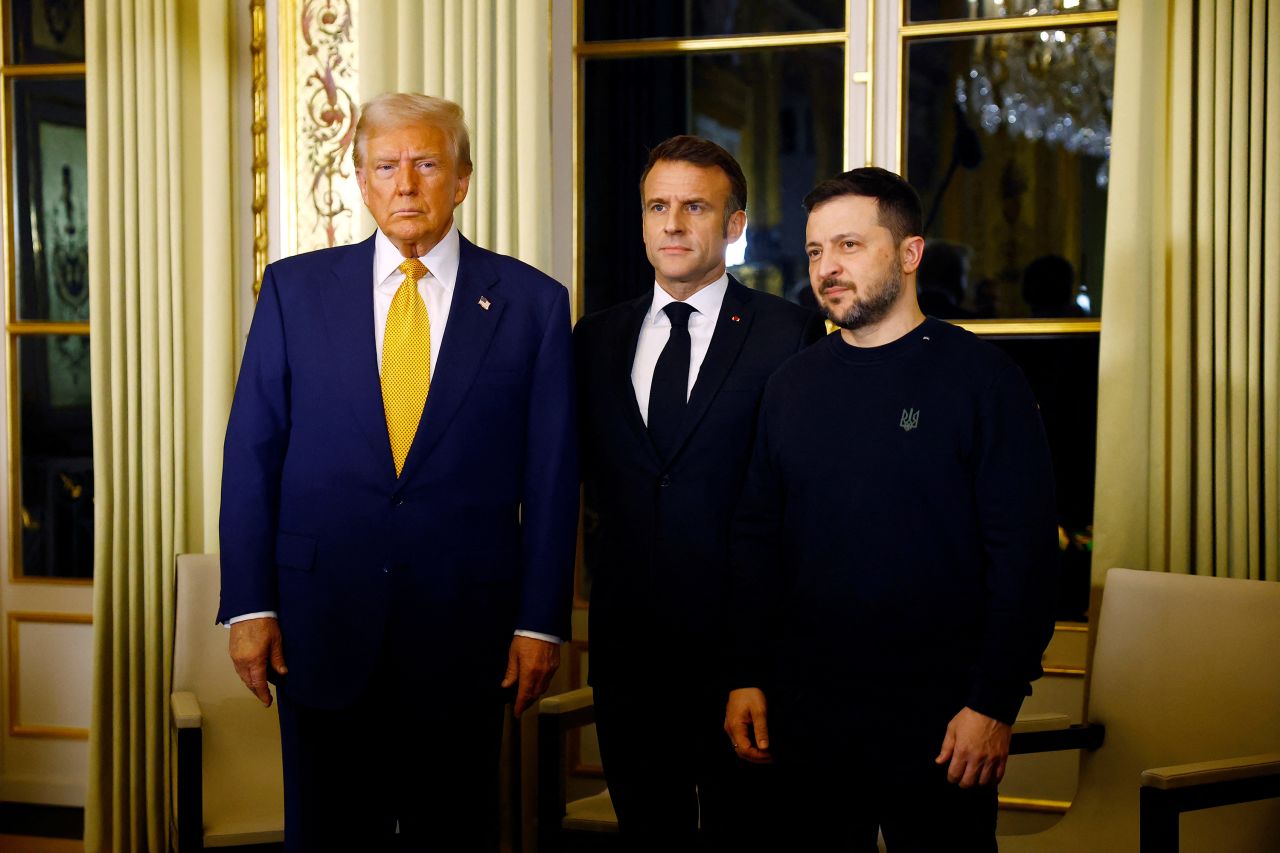 French President Emmanuel Macron poses with U.S. President-elect Donald Trump and Ukraine's President Volodymyr Zelenskiy before a trilateral meeting at the Elysee Palace in Paris as part of ceremonies to mark the reopening of the Notre-Dame de Paris Cathedral, five-and-a-half years after a fire ravaged the Gothic masterpiece, after its restoration, in Paris, France, December 7, 2024. REUTERS/Sarah Meyssonnier/Pool